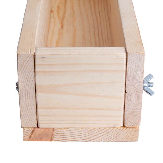 Front view of a handcrafted wooden soap loaf mold made from durable pine with adjustable end secured by metal wingnuts, featured in Health & Wellness and Soapmaking Supplies collections.