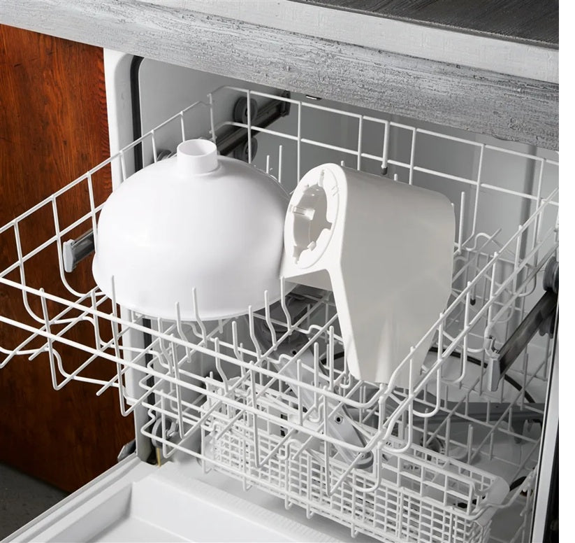 White plastic components of an electric tomato strainer placed in an open dishwasher rack, illustrating easy cleaning for Kitchen & Food, Food Prep, and Food Mills collections.