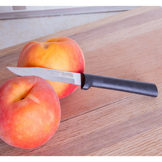 Handcrafted serrated paring knife with fine high carbon stainless steel blade and smooth black handle, made in USA, shown with fresh peaches on wooden cutting board, ideal for kitchen food prep and Farm, Garden & Tool collections.