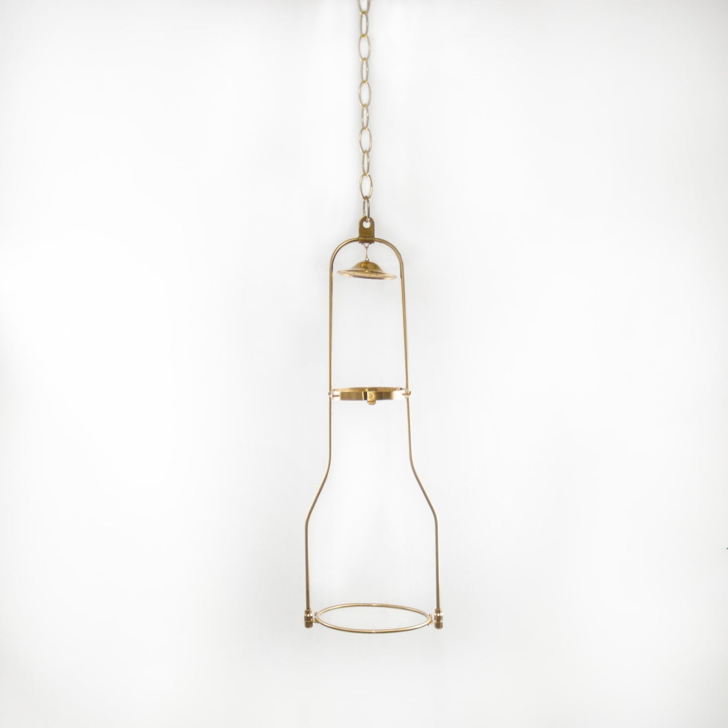 Solid brass hanging bracket designed for oil lamps, showcasing a vintage-inspired frame suspended by a chain, ideal for lamps and lighting collections.