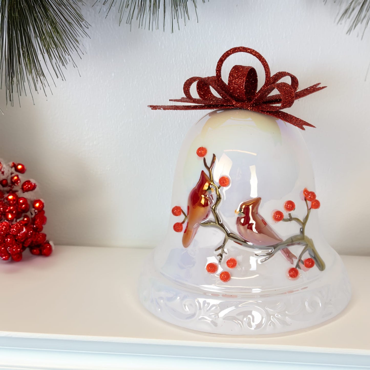 Unique handcrafted dolomite bell featuring red cardinals on a branch with red berries and a glittery red bow, offering warm holiday charm for Home & Decor, Holiday Decor, Promo Eligible collections.