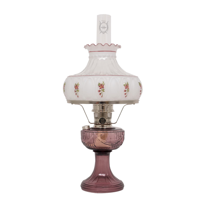 Handcrafted Aladdin glass oil lamp featuring a purple Lincoln Drape base, delicate rose-accented white glass shade with scalloped edge, clear chimney, and polished brass burner, ideal for Farm, Garden & Tool, Lamps & Lighting, Oil Lamps, Table Lamps, Best Sellers, Homesteading, and Promo Eligible collections.