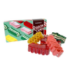 Assortment of handspun ribbon candy in various flavors and colors displayed next to a festive gift box, part of USA Made Snacks and Sweets collections.