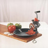 Handcrafted food chopper with metal body and crank handle clamped to a wooden surface, grinding fresh tomatoes into sauce, ideal for Kitchen & Food, Specialty Equipment, Butchering Supplies, USA Made, and Best Sellers collections.