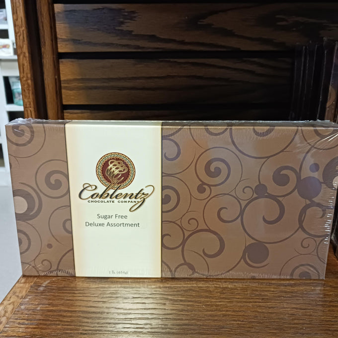 Box of sugar-free deluxe chocolate assortment with elegant swirling pattern on packaging, handcrafted in Amish Country, featured in Kitchen & Food and Snacks and Sweets collections.