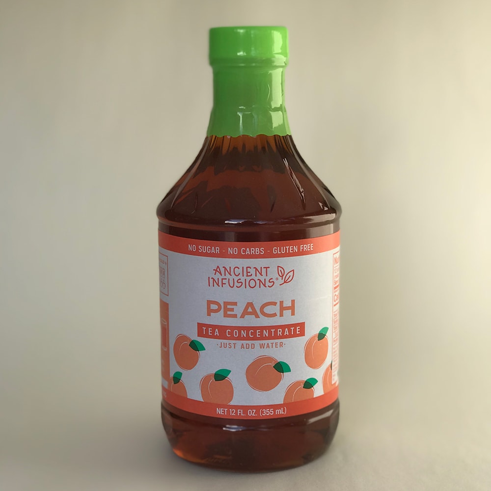 Handcrafted peach tea concentrate with green cap, made in USA, gluten-free and no sugar, part of Kitchen & Food, Beverages, USA Made, Best Sellers, and Promo Eligible collections.