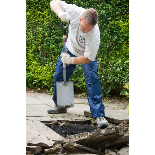 Person using a Spear & Jackson Neverbend treaded digging spade with a forged carbon steel head and sturdy handle to remove soil and broken pavement, suited for Farm, Garden & Tool, Digging and Cultivating, Lawncare, Best Sellers, and Promo Eligible collections.