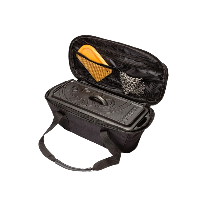 Black transport bag with sturdy handles holding a cast iron loaf pan and baking accessories, designed for secure storage and travel, ideal for camping, bread making, and farm tools.