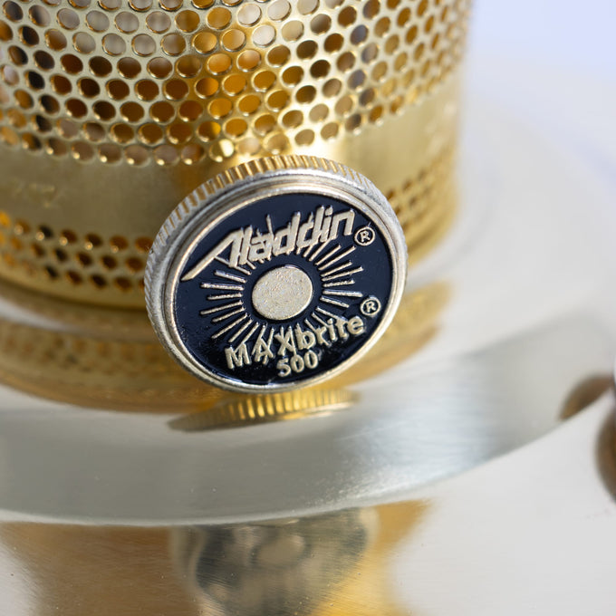 Close-up of a solid brass control knob embossed with vintage-style logo and text for bright oil lamp use in farm, garden, emergency, and lighting supplies collections.