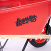 Close-up of a bright red handcrafted kids wheelbarrow with wooden handles and a black Lehman’s logo, designed for outdoor play and garden activities in children’s toy collections.