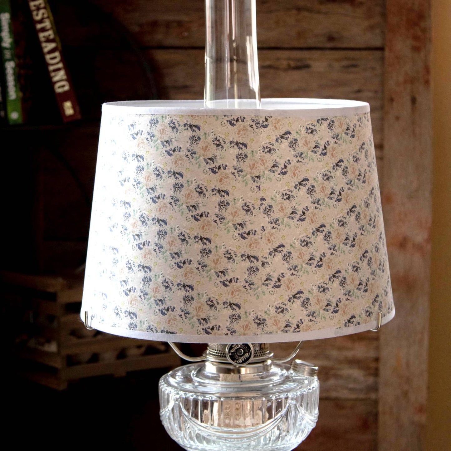 Handcrafted floral tapestry parchment shade with soft blue and green hues, designed to gently diffuse light on oil lamps, part of Lamps & Lighting and Lamp Shades collections.