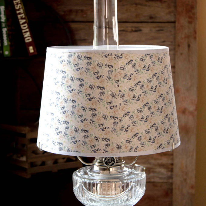 Handcrafted floral tapestry parchment shade with soft blue and green hues, designed to gently diffuse light on oil lamps, part of Lamps & Lighting and Lamp Shades collections.