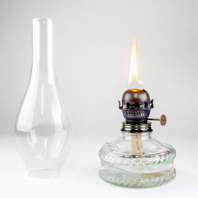 Handcrafted reflector oil lamp with clear glass base and fabric wick lit, featuring a removable tall glass chimney, ideal for Lamps & Lighting, Oil Lamps, Wall Lamps, Best Sellers, Promo Eligible, and Sale collections.