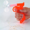 Handcrafted bright orange plastic Fly Shooter with spring-loaded mechanism and attached string, held in hand, ideal for Farm, Garden & Tool, Garden Accessories, USA Made collections.