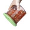 Hand holding a flexible green-lidded vacuum seal container filled with fresh tomato and vegetable salsa, designed for Kitchen & Food, Food Preservation, and Storage collections.