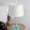 Handcrafted floral tapestry parchment shade with delicate blue and beige pattern on a clear glass oil lamp, featured in Lamps & Lighting, Parts and Accessories, and Lamp Shades collections.