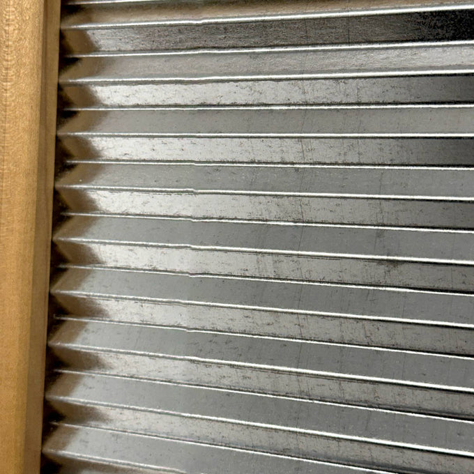 Close-up of a handcrafted galvanized wavy scrubbing surface with a smooth wooden frame, part of a miniature washboard ideal for Home & Decor, Laundry Supplies, and USA Made collections.