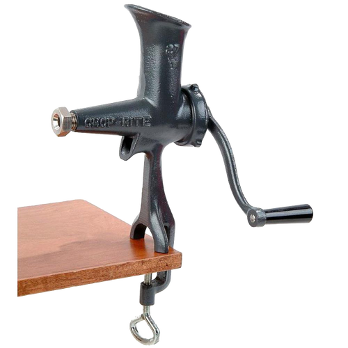 Compact cast iron wheatgrass juicer with black Xylon finish, hand-crank, and clamp base attached to a wooden surface, ideal for Kitchen & Food and USA Made collections.