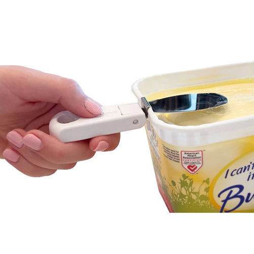 Hand holding a SnapAway foldable, attachable butter knife with a white collapsible handle clipped to a rectangular yellow butter tub for easy spreading, featured in Kitchen & Food, Kitchen Gadgets, Kitchen Accessories, Best Sellers, and Promo Eligible collections.