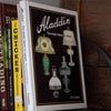 Hardcover book featuring a detailed history of classic Aladdin lamps with black and white images, perfect for Toys, Books & Games, Heritage and Lifestyle Books, and Best Sellers collections.