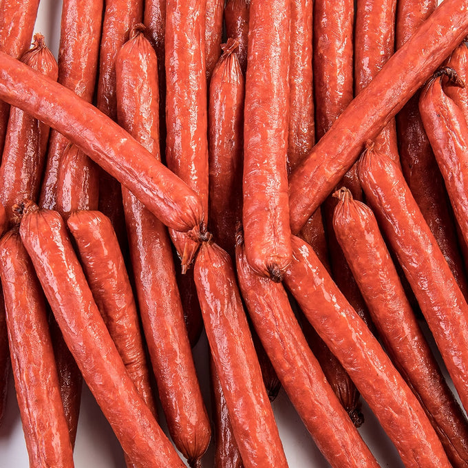 Close-up of handcrafted hickory smoked snack sticks made from pork and beef, offering a savory, flavorful option for Kitchen & Food, Snacks and Sweets, Meats, USA Made, Best Sellers, and Promo Eligible collections.