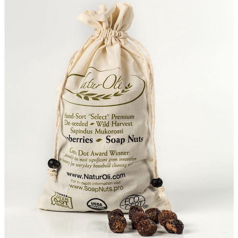 Natural cotton drawstring bag filled with organic soap nuts, featuring hand-sorted wild harvest labels and eco-certification marks, ideal for natural laundry and home care collections.