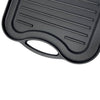 Close-up of nitrogen hardened cast iron griddle with ribbed surface and ergonomic handle, handcrafted for reliable grilling in Kitchen & Food and Cast Iron cookware collections.
