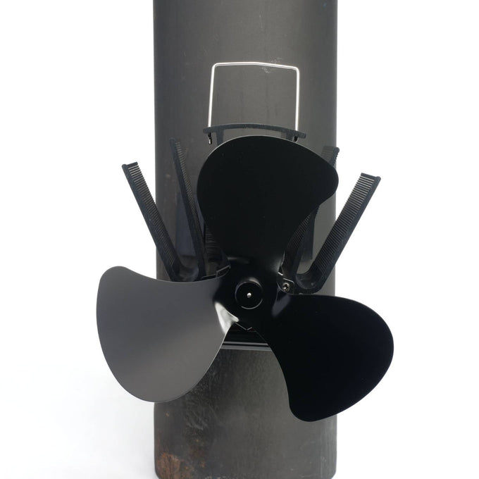 Black three-bladed magnetic fan mounted on a stove flue pipe, designed to circulate warm air efficiently, featured in Stoves, Hearth Accessories, Best Sellers, and Promo Eligible collections.