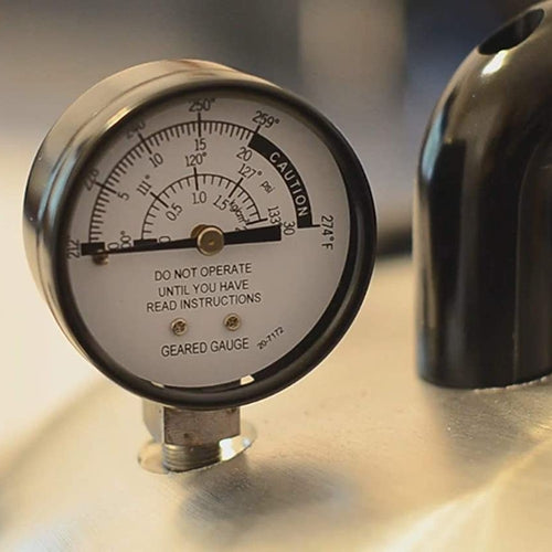 Close-up of a handcrafted pressure gauge displaying temperature and pressure readings on a stainless steel surface, part of Kitchen & Food, Food Preservation, and Pressure Canners collections.