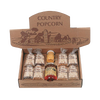 Open box featuring eight small bags of handcrafted popcorn kernels and two jars of Amish-made seasoning and syrup, highlighting USA made quality for Kitchen & Food, Snacks and Sweets, Popcorn, Amish Made, and Best Sellers collections.