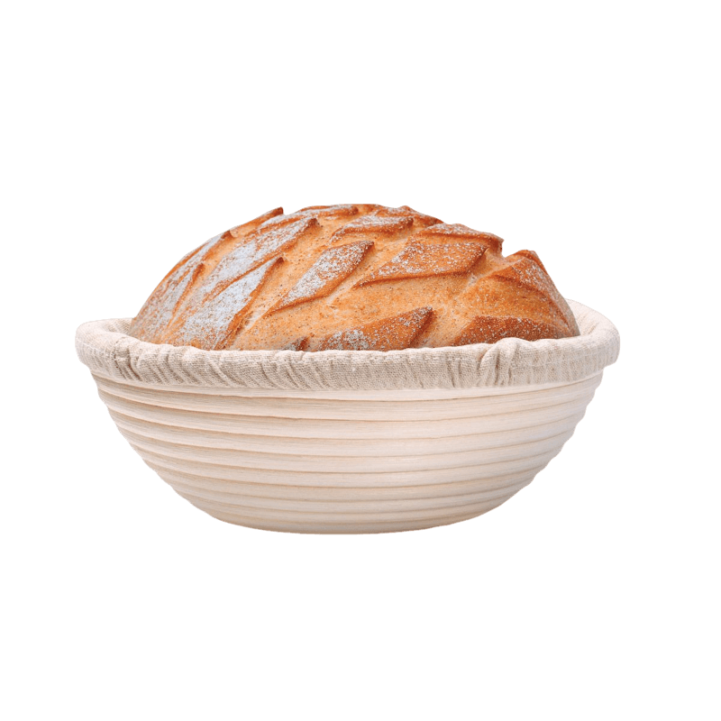 Handcrafted rattan bread proofing basket with a natural removable liner holding a golden artisan loaf, ideal for Kitchen & Food, Baking Supplies, and Bread Making collections.