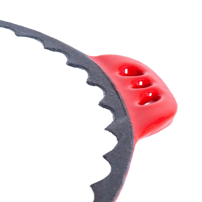 Close-up of a handcrafted cast iron pie pan edge with decorative crimps and a red handle detail, highlighting durable construction for Kitchen & Food, Cookware, and Baking Supplies collections.