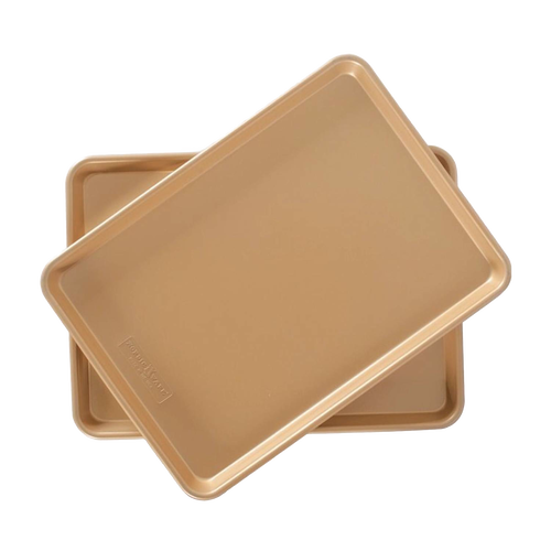 Two gold interior nonstick aluminum half-sheet baking pans stacked, designed for even heating and easy release, perfect for kitchen, cookware, baking supplies, and USA made collections.