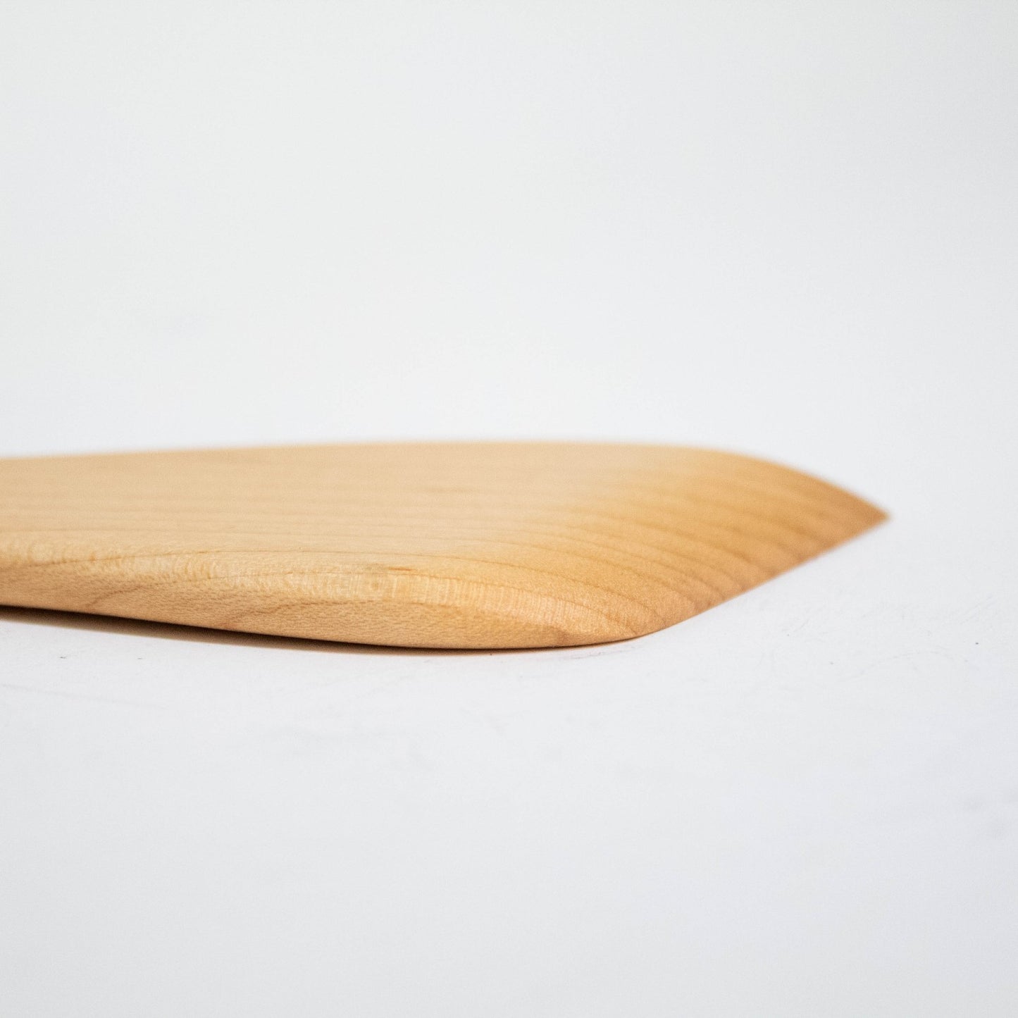 Close-up of a handcrafted solid American Hard Maple wooden spatula with a smooth, polished finish, perfect for Kitchen & Food, Holiday Hosting, Storage and Serving, and USA Made collections.