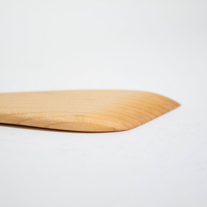Close-up of a handcrafted solid American Hard Maple wooden spatula with a smooth, polished finish, perfect for Kitchen & Food, Holiday Hosting, Storage and Serving, and USA Made collections.