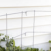 Close-up of a handcrafted metal pea fence in a garden setting, providing sturdy plant support for peas and straw bale gardens, made in USA and featured in Farm, Garden & Tool collections.