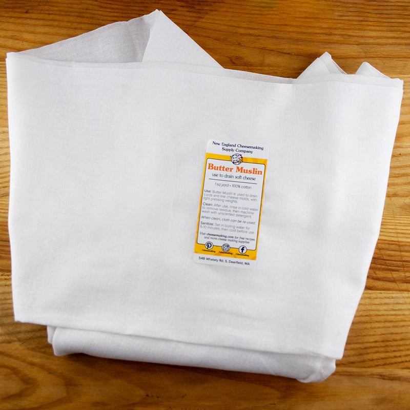 Piece of heavy-duty, tightly woven 100% cotton butter muslin used for draining soft cheeses, shown folded on a wooden surface, ideal for Kitchen & Food and DIY Cheese collections.