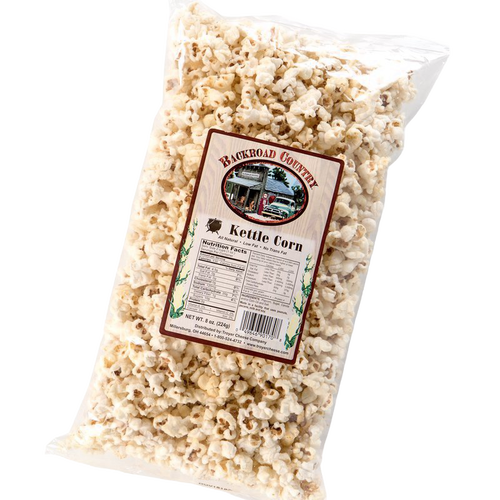 Clear plastic bag filled with crunchy, lightly sweetened kettle corn with label showing local country store, handcrafted in USA, featured in Kitchen & Food, Snacks and Sweets, Popcorn, and USA Made collections.
