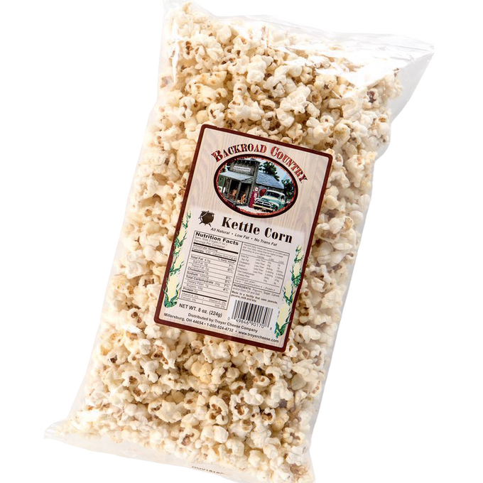 Clear plastic bag filled with crunchy, lightly sweetened kettle corn with label showing local country store, handcrafted in USA, featured in Kitchen & Food, Snacks and Sweets, Popcorn, and USA Made collections.
