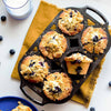 Handcrafted cast iron muffin pan with six golden-brown blueberry muffins, showcasing even baking and browning, perfect for Kitchen & Food, Cookware, Cast Iron, Baking Supplies, USA Made, and Best Sellers collections.