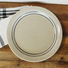 Hand-thrown stoneware dinner plate featuring two blue stripes on a natural off-white base, dishwasher and microwave safe, part of Kitchen & Food and USA Made collections.
