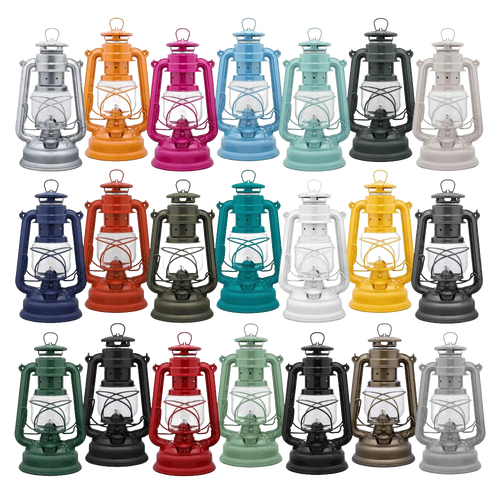 A handcrafted assortment of vibrant Feuerhand galvanized oil lanterns in various colors, featuring thermal heat-resistant SUPRAX globes, ideal for Lamps & Lighting, Camping, and Emergency Supplies collections.