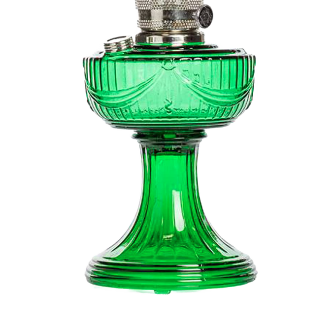 Handcrafted emerald green glass oil lamp with a sweeping drape font and brass trim, offering vintage charm and 10-12 hour burn time, ideal for Lamps & Lighting and Table Lamps collections.