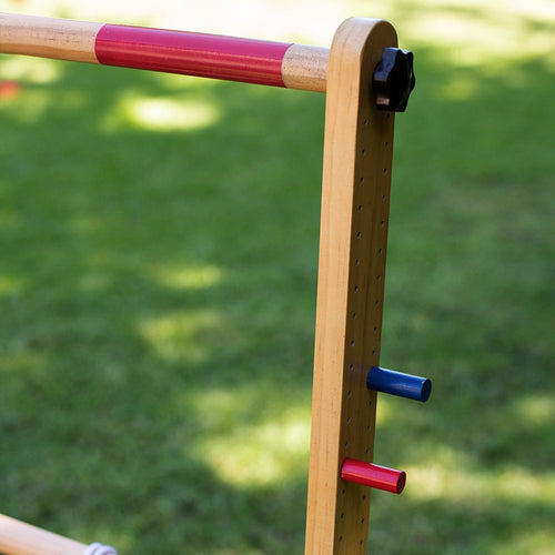 Close-up of a handcrafted wooden ladder frame with adjustable rungs in red and natural finish, highlighting blue and red peg supports for an outdoor lawn game in Toys, Books & Games, Lawn Games, Best Sellers, and Promo Eligible collections.