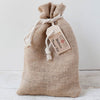 Handcrafted burlap pouch tied with a white rope holding a compact wellness travel kit tag, designed for Health & Wellness, Health Remedies, Best Sellers, and Promo Eligible collections.