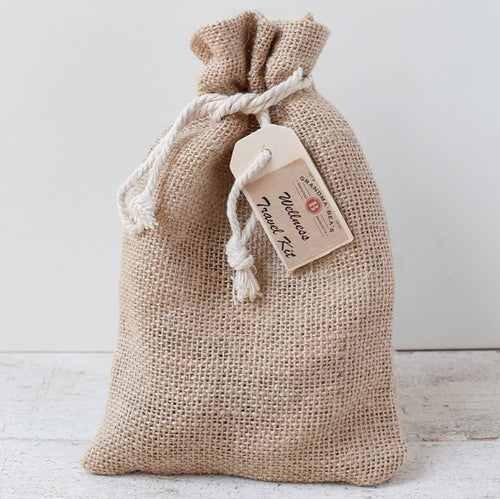 Handcrafted burlap pouch tied with a white rope holding a compact wellness travel kit tag, designed for Health & Wellness, Health Remedies, Best Sellers, and Promo Eligible collections.