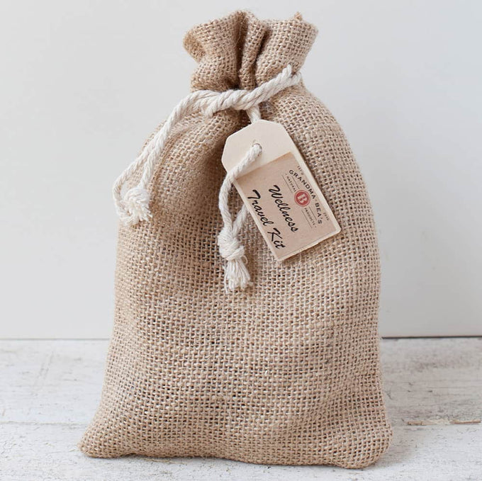 Handcrafted burlap pouch tied with a white rope holding a compact wellness travel kit tag, designed for Health & Wellness, Health Remedies, Best Sellers, and Promo Eligible collections.