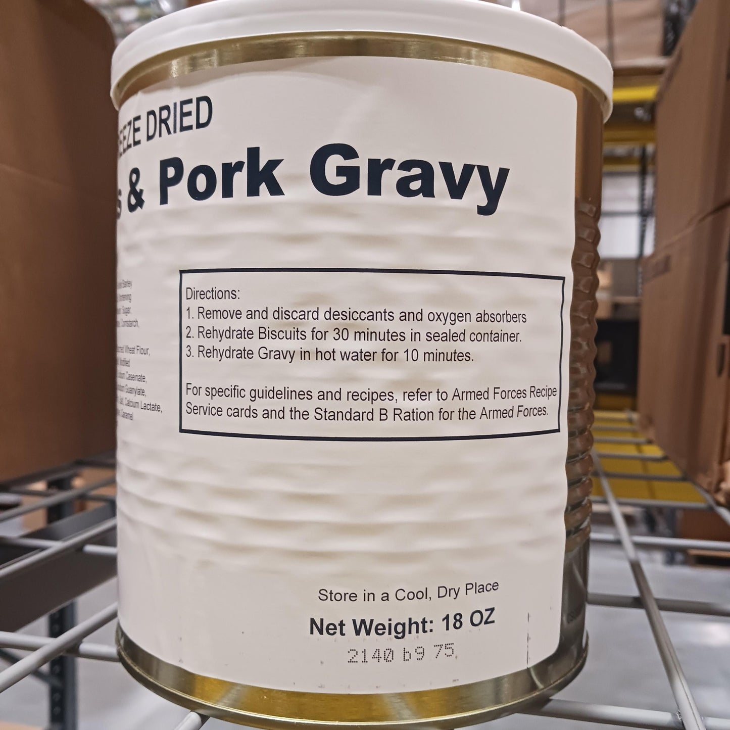Large metal canister of freeze-dried biscuits with pork gravy, featuring preparation instructions and storage advice, ideal for emergency supplies and long-term food storage.