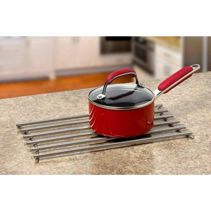 Steel trivet with rounded wires and modern finish holding a red saucepan on a kitchen countertop, part of Kitchen & Food, Dinnerware, Kitchen Gadgets, and Storage and Serving collections.