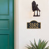 Handcrafted arched rectangle address plaque with black background and gold numbers, mounted on a light wall beneath a vintage-style outdoor lantern, featured in Home & Decor, Household Helpers, Mailboxes and Address Signs, USA Made, Best Sellers, and Promo Eligible collections.